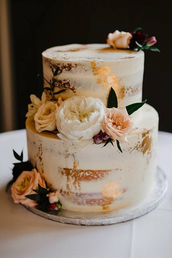 15+ idées de micro-mariages qui transformeront votre espace de cérémonie et de réception image 10 | Soirée Blanche Petit gâteau de mariage élégant avec des accents dorés et des fleurs.