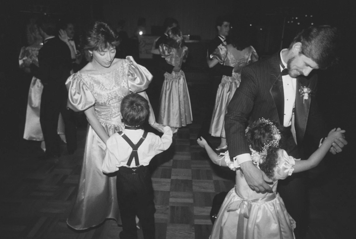 Le marié danse avec la demoiselle d'honneur tandis qu'une demoiselle d'honneur danse avec le porteur de l'alliance, 1989